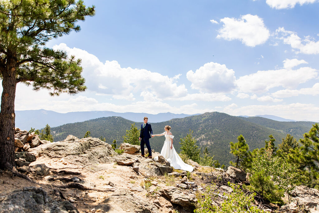 Wedding couple walking on mountaintop in Colorado Colorado Wedding Photographer Colorado Wedding Photographer