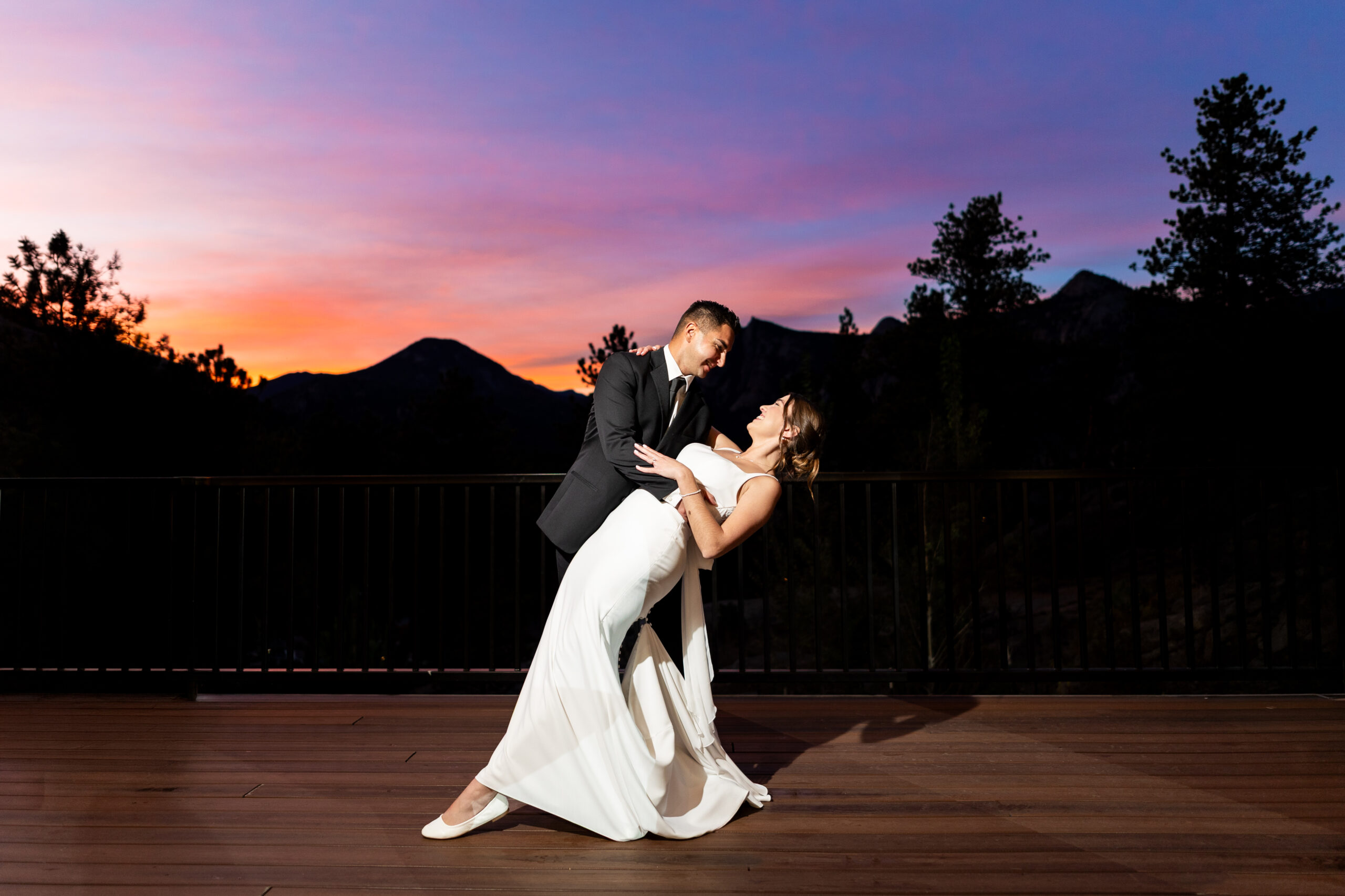 SG2_7068-Edit - Colorado Wedding Photographer Wedding Couple Dipping at Sunset with colorful sky in Estes Park Colorado Colorado Wedding Photographer